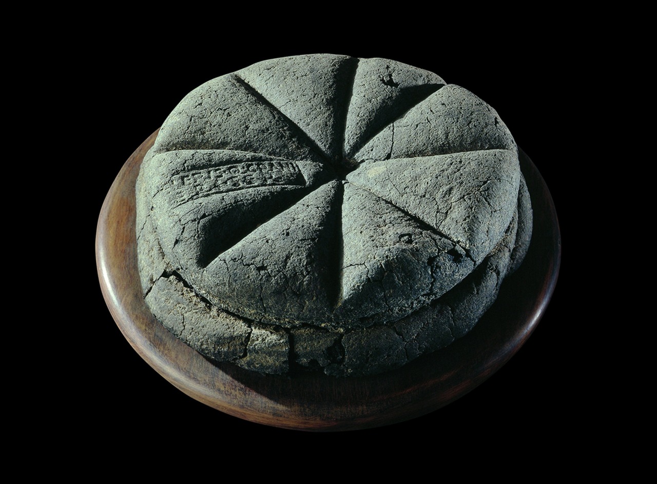 A carbonised by volcanic ash loaf of bread with the stamp ‘Property of Celer, Slave of Q. Granius Verus’, Herculaneum (near Pompeii), 79 AD